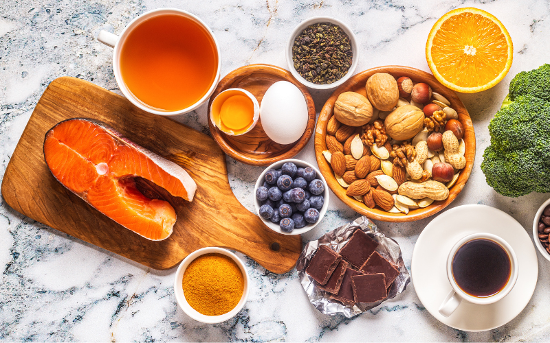 Healthy breakfast ingredients with fruit, nuts and salmon